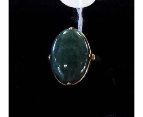 A yellow coloured metal and jade ring
