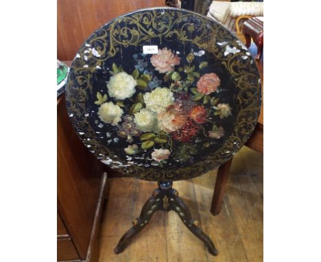 A papier mâché style tripod table, with painted floral decoration, 60 cm diameter