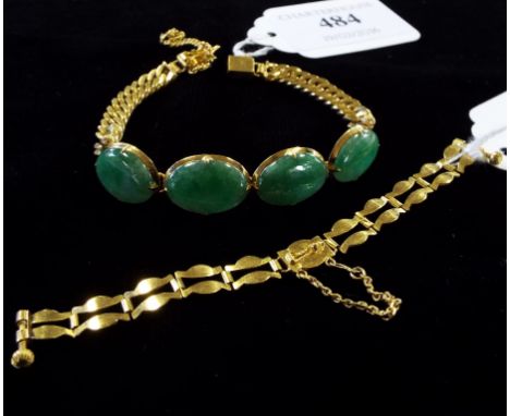 A yellow coloured metal and jade bracelet, set four oval panels, with interchangeable strap (2)