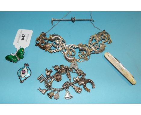 A Norwegian silver and green enamel butterfly brooch, a silver and mother of pearl fruit knife, a silver charm bracelet, and 