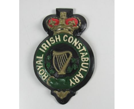 Artefact: A heavy cast metal and painted R.I.C. (Royal Irish Constabulary) Wall Plaque (replica) decorated with shamrocks and
