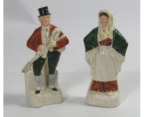 An attractive pair of antique Staffordshire Irish Figures, "The Irish Piper," playing the uillean pipes, and "The Irish Colle