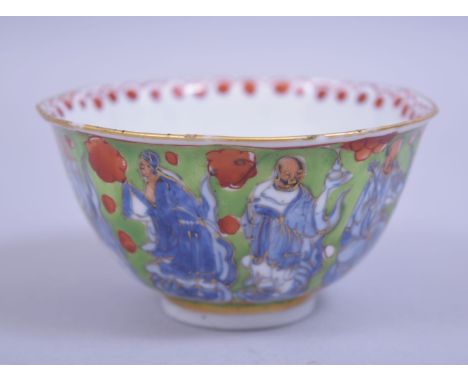 A CHINESE KANGXI PERIOD UNDERGLAZE BLUE AND ENAMEL IMMORTAL TEA BOWL, underglaze blue immortals with green and red enamels an