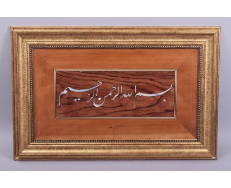 A TURKISH ISLAMIC MOTHER OF PEARL INLAID ROSEWOOD AND SATINWOOD PANEL, the mother of pearl inlay in the form of calligraphy, 