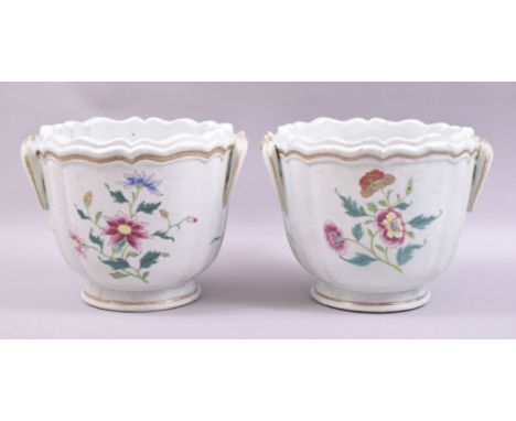 A PAIR OF CHINESE FAMILLE ROSE PORCELAIN WINE COOLERS, each with moulded handles and decorated with sprays of colourful flowe