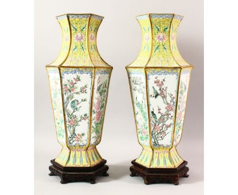 A LARGE PAIR OF CHINESE ENAMEL VASES &amp; STANDS, the vases decorated upon a yellow ground with panels of birds in trees, ea