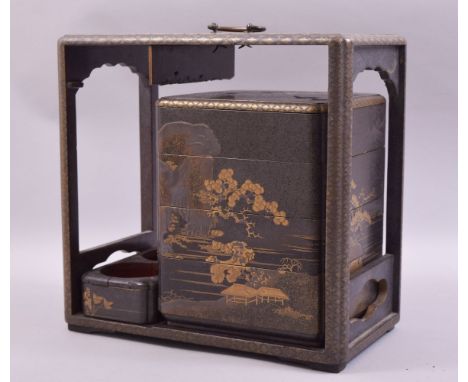 A 19TH CENTURY JAPANESE LACQUER PICNIC BOX with gilt decoration, the box containing four stacking trays and two flask holders