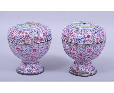 A PAIR OF 19TH CENTURY CHINESE CANTON ENAMEL BOX AND COVERS, decorated with figures in landscapes and flora, 10.5cm high.