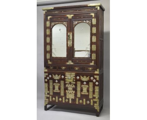 A CHINESE STAINED PINE AND MOTHER OF PEARL INLAID CABINET ON CHEST, comprising two large hinged doors above four small drawer