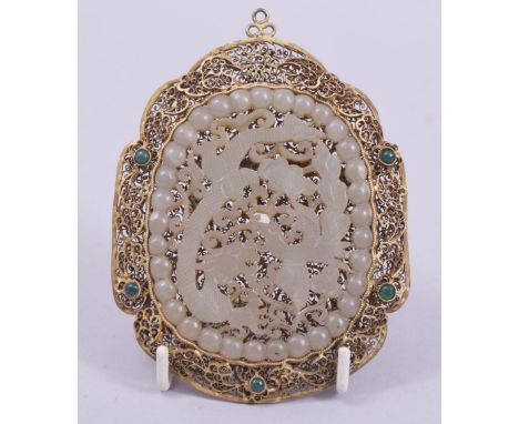 A LARGE CARVED JADE AND GILT FILIGREE PENDANT, 11.5cm x 8.5cm.