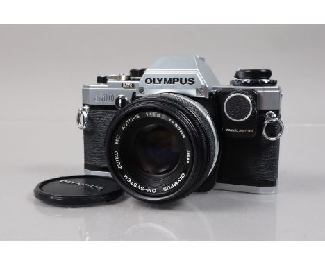 An Olympus OM-10 SLR Camera, shutter working, meter responsive, self timer working, body G, light paint scratches to film doo