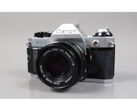 A Canon AE-1 Program SLR Camera, serial no 2948053, shutter working, meter responsive, self timer working, body G, light wear