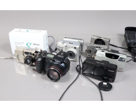 A Small Tray of Canon and Nikon Compact Cameras, comprising a boxed Canon PowerShot Pro 1, a PowerShot A470, a Sureshot 60 Zo