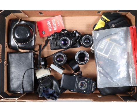 A Canon A-1 SLR Camera and Lenses, body G, finger grip missing, shutter working with "squeek", meter reacts to light, FDn 50m
