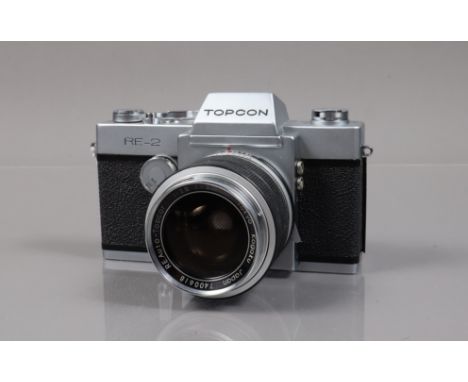 A Topcon RE-2 SLR Camera, shutter working, meter unresponsive, self toner working, body G-VG,  some scratching to tripod moun