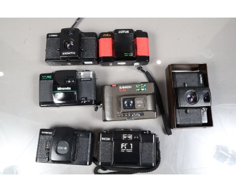 A Group of 35mm Compact Cameras, a Ricoh FF 1, two Lomo LC-A, a Miranda 35 ME, a Lotus ME 35, a Soviet made S35, all shutters