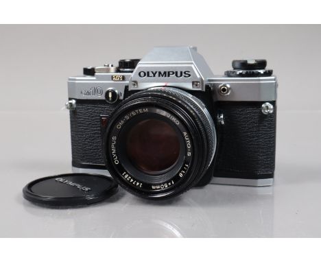 An Olympus OM-10 SLR Camera, shutter working, meter responsive, self timer working, body G-VG, with F Zuiko 5mm f/1.8 lens, b