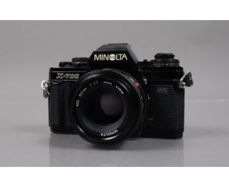 A Minolta X-700 SLR Camera, shutter working, meter responsive, body G, light wear, with MD 50mm f/1.7 lens, elements G, with 