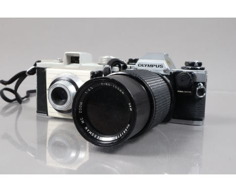 An Olympus OM10 SLR Camera and Other Items, an OM10 body with manual adapter, serial no 1763756, shutter working, meter react