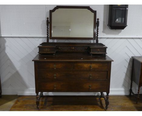 A vintage oak Dressing Table, the swing mirror with barley twist supports above two small drawers, the chest below with two s
