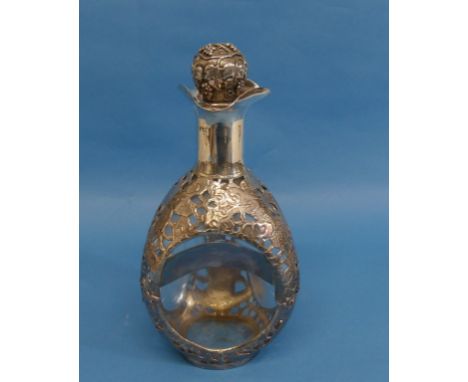 A Haigs 'Dimple' Decanter, with silvered overlay piered with dragons amongst foliage, the fruit and vine decorated stopper ma