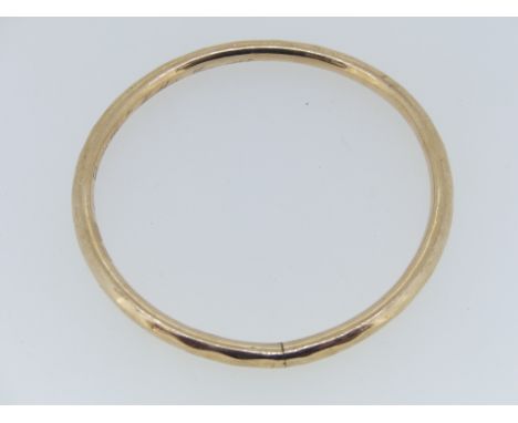 A 9ct rose gold hollow Bangle, with inscription, approx weight 9.5g.