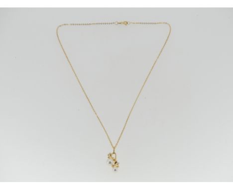 An 18ct gold Mikimoto cultured pearl Pendant and Chain, the cultured pearls mounted one above the other, with two small diamo