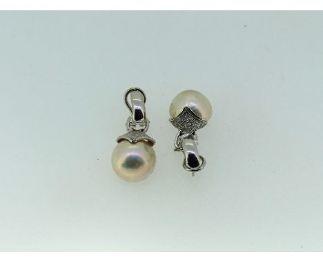 A pair of 18ct white gold and cultured mabe pearl Earrings, the pillar and clip fittings suspending the pearls in a textured 