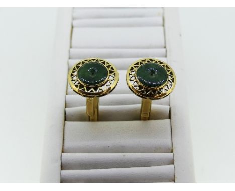 A pair of 14k gold and jade Cufflinks, the fronts with a circular jade disc in pierced gold mount, hinged bar reverse, approx