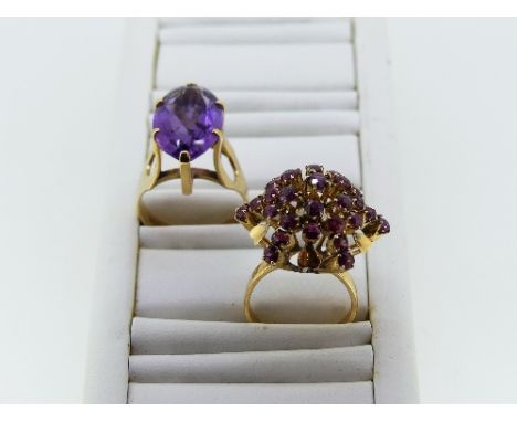 A 14k yellow gold and amethyst Dress Ring, the facetted oval amethyst approx 19mm x 12mm, together with a pale ruby flower he