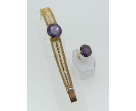 A yellow gold Bracelet, the front with a circular facetted colour change sapphire (resembling Alexandrite tones) on a mesh br