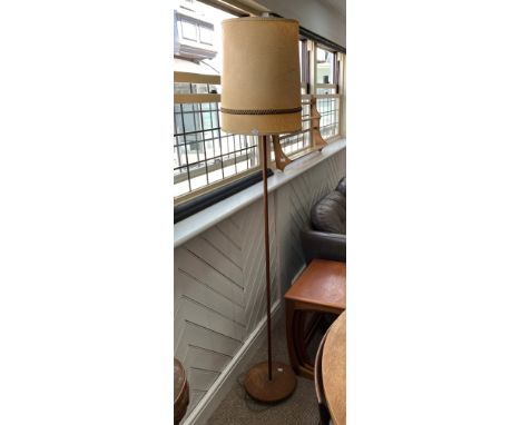 A retro teak Standard Lamp, the long pole housing the lamp and shade, stood upon circular base with brass inset, 68in (173cm)