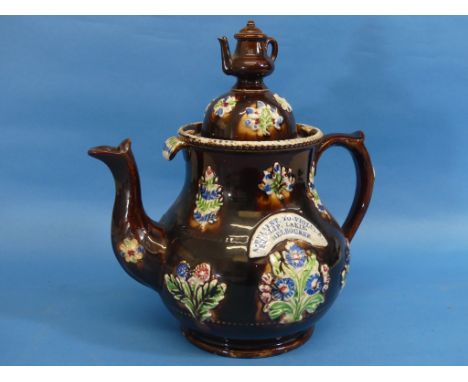 A Victorian Bargeware treacle glazed Teapot and cover, the body applied with relief moulded floral decoration, and applied ca