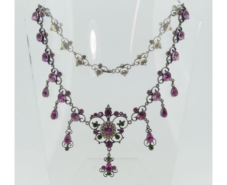 A Palais Royale style paste Necklace, set with eight open scroll links each set two pink pastes and seed pearl, two further l