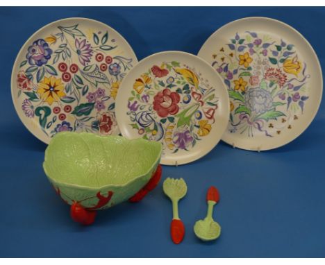 A pair of Poole pottery floral Chargers, 12¼in (31cm) diameter, and another similar, smaller, together with a Carlton Ware 'L