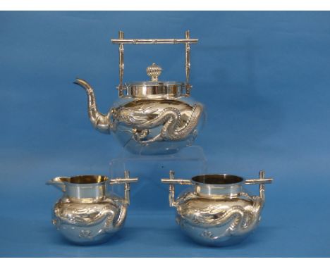 A Chinese export silver three piece Tea Set, by Wang Hing, Canton, of circular form with 'bamboo' stylised handls, the teapot