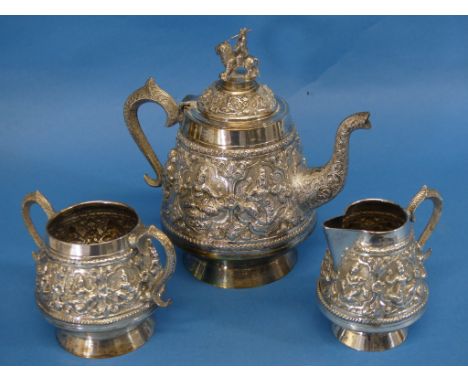 An Indian silver three piece Tea Set, of circular form with scroll handles, the teapot with finial depicting Durga riding a l
