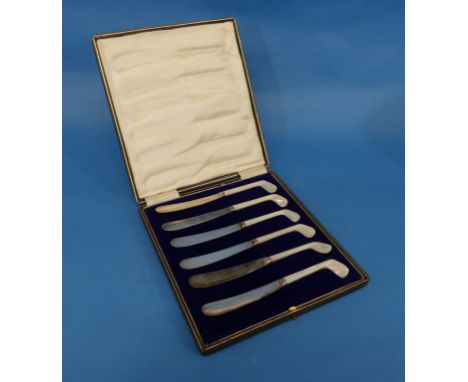 Golf Interest; An early 20thC cased set of six silver plated Butter Knives, with mother of pearl handles in the form of golf 