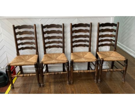 A set of four early 20thC oak Ladder-back Chairs, the laddered back over the envelope rush seats, raised on stretchered suppo