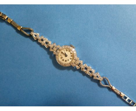 A 9ct white gold and diamond Cocktail Watch, early 20th century, manual wind, the silver dial with black Arabic numerals, the
