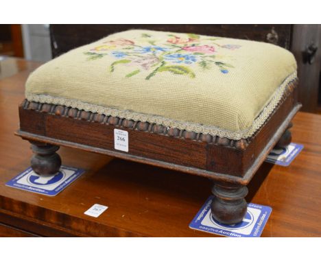 An upholstered footstool.