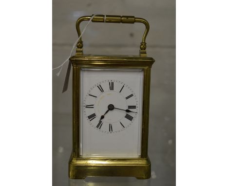 Large brass carriage clock with leather travelling case and key.