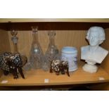 A pair of cut glass decanters, decorative model elephants and other items.