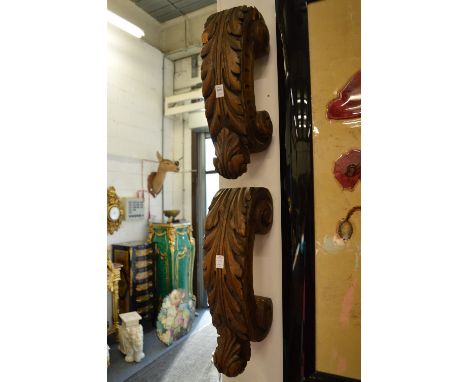 A pair of acanthus carved C scroll brackets and another carved item.