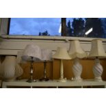 Two pairs of table lamps and three other lamps.