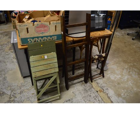 Two small green painted folding step ladders, another ladder and a folding chair.