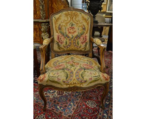 A French beech framed and needlework upholstered fauteuil.