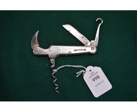 A silver mounted multi-tool with leather case.