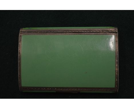 A small silver and green enamel cigarette case.