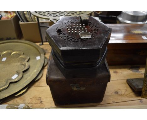 A concertina with original box.